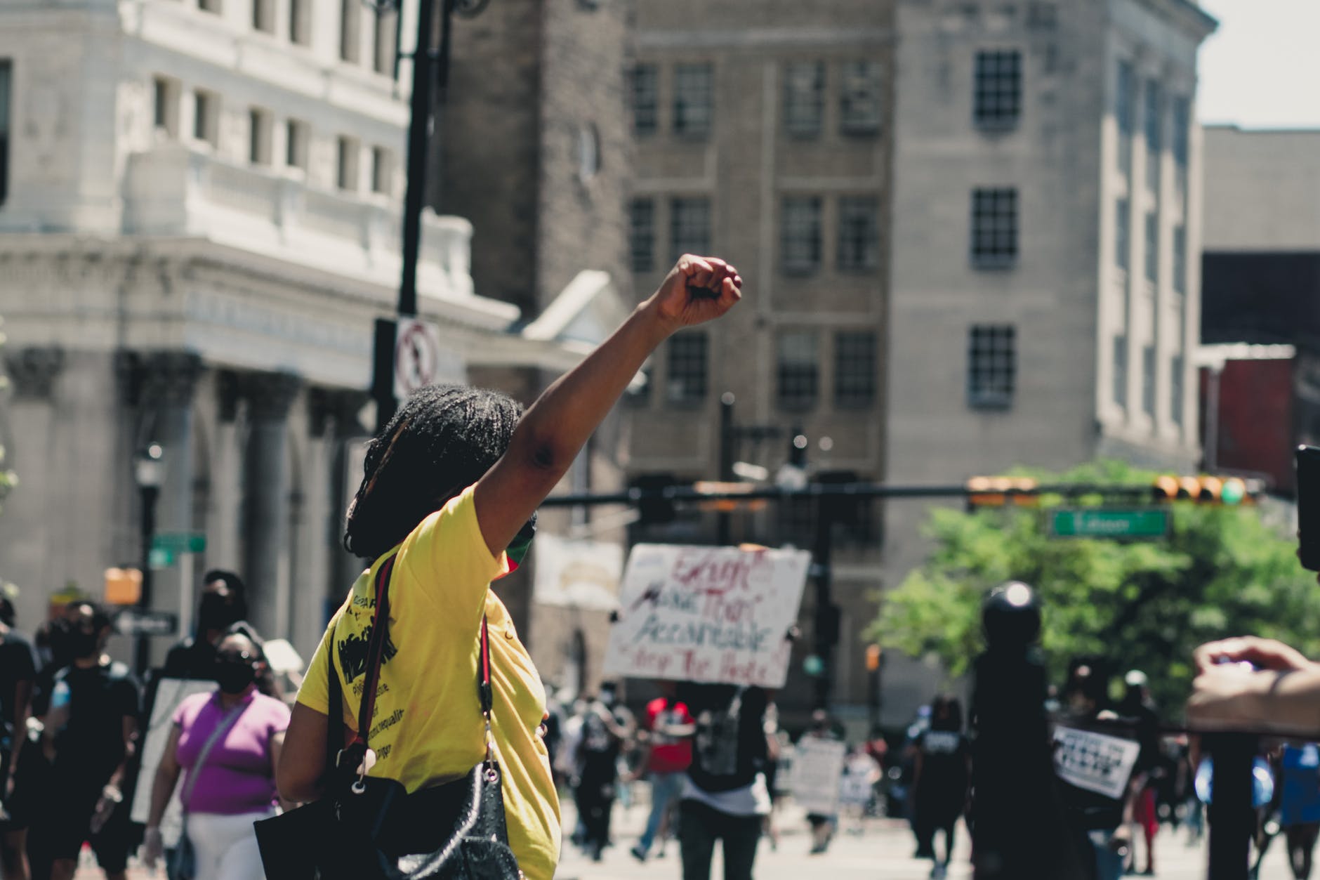black woman protesting on city street
