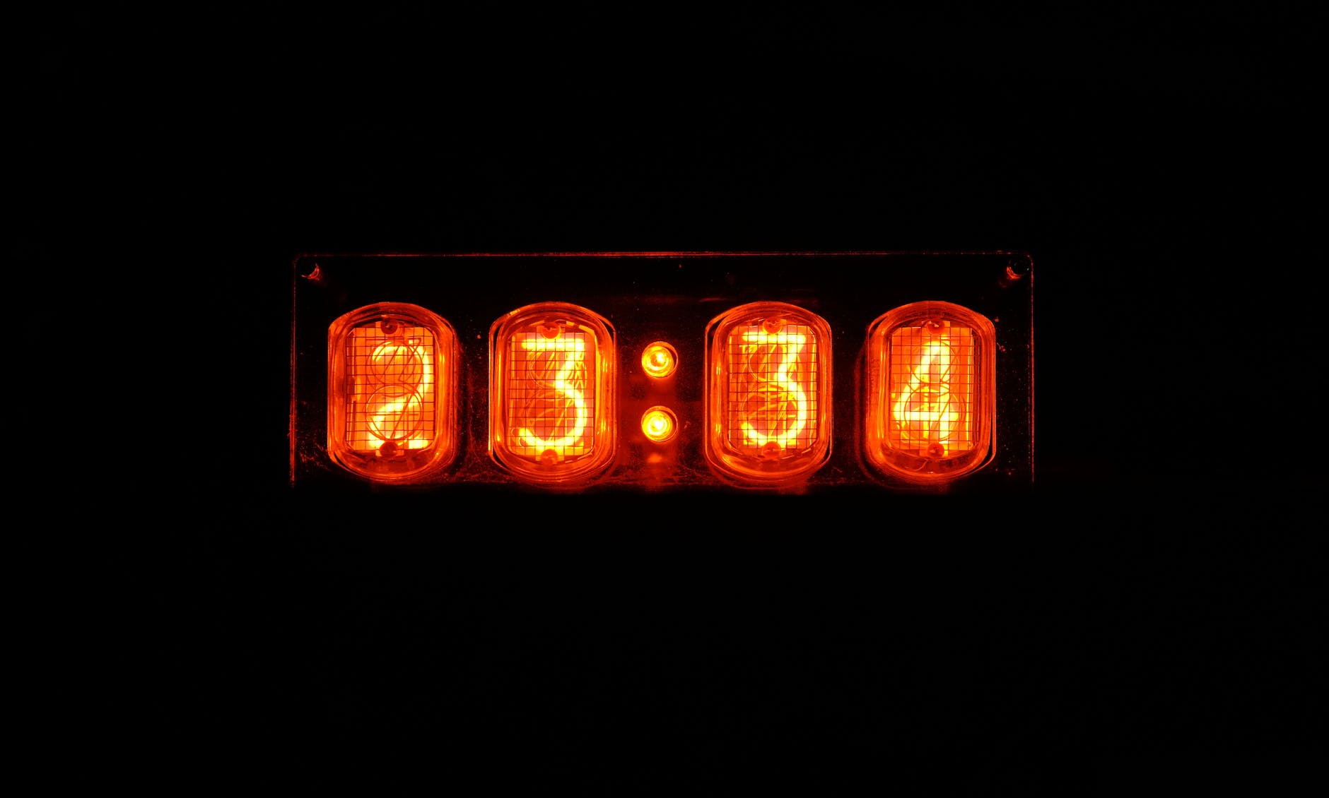 a clock with neon lights showing time